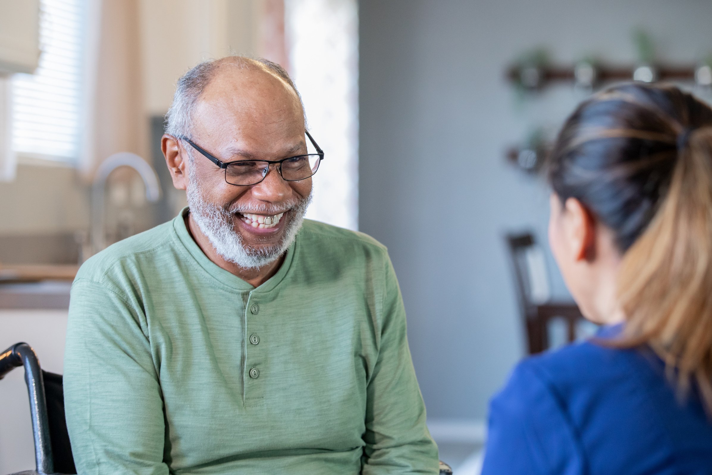 Disabled senior male talking with home health aid